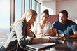 © ReeseArcurs/peopleimages.com - Invest, financial advisor or couple at table in meeting for budget, policy update or paper in office. Broker, discussion or consultation with people for life insurance, strategy or contract review