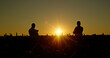 © StockMediaSeller - Two confident farmers admire the beautiful sunset over a cornfield