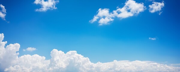 Wall Mural - clear blue sky with scattered white clouds. The horizon is visible with more clouds near it.