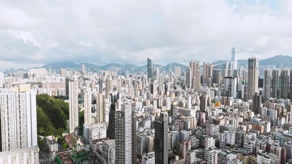 Wall Mural - Establishing shot of Hong Kong city, drone aerial cityscape high angle view. Skyscraper in business district, downtown residential buildings, car traffic transportation on road. Asia city life concept