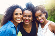 © peopleimages.com - Outdoor, portrait and black women with smile, love and friends in park for vacation, together and hug. Nature, girls and trip to woods for peace, break and embrace for care, bonding and travel