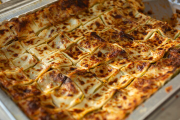 Wall Mural - A closeup view of a catering size tray of lasagna.