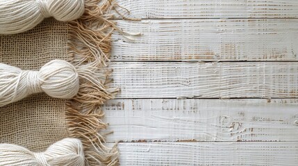 Hemp canvas and threads on a white wooden surface  Hemp canvas and threads on a white wooden surface