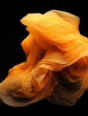 Wall Mural - an orange cloth is floating in the air on a black background