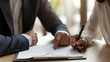 © Rajib - signing a partnership agreement at a desk, formal wear, office environment,