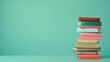 © Kate Mova - Stack of books on turquoise background, copy space