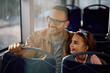 © Drazen - Happy father and daughter looking through  window while commuting by bus.