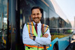© Drazen - Happy bus driver standing with arms crossed at looking at camera.