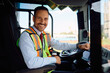 © Drazen - Happy public transport driver behind the wheel in bus cabin looking at camera.