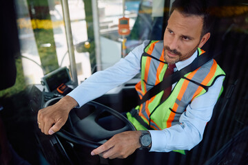 Mid adult man working as bus driver.