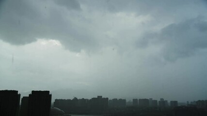 Wall Mural - Time lapse of city Skyline surrounded by heavy rain coming into the city during thunderstorm with clouds and fog