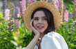 © schankz - Portrait of a girl wearing a straw hat in lupine colors