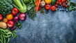 © Kasitthanin - Assortment of fresh fruits and vegetables on a blue background with copy space.