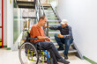 © unai - Man with disability talking with colleague in coworking coffee break