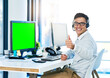 © TamJam/peopleimages.com - Happy man, computer and thumbs up with green screen in portrait with virtual assistant, headset and mockup. Male person, yes and crm for sales, bonus and lead in telemarketing or customer service