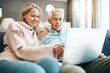 © Penn/peopleimages.com - Home, relax and senior couple with laptop on sofa for online travel booking, information and decision. Man, woman and love with tech in living room for trip plan, web registration and reading reviews