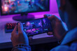 © Arsenii - Close-up of a person playing a competitive mobile game in a neon-lit room, with a desktop gaming setup in the background. Professional mobile gaming concept as part of Esports, cybersport.
