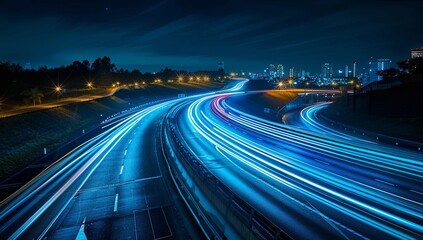 Canvas Print - A highway at night with a city in the background