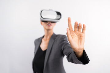 Wall Mural - Professional female leader touching at program or working while using VR glasses. Skilled businesswoman pointing at system while connecting at metaverse by wearing visual reality goggles. Contraption.