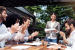 © peopleimages.com - Cafe, business people and applause for presentation, person and feedback report for finance project. Restaurant, professional career and accountant for promotion, staff and celebrate with clapping