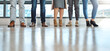 © peopleimages.com - Business people, closeup and legs in workplace, shoes and creative agency for cooperation, waiting and group. Feet, footwear and employees in office, colleagues and startup for graphic designer