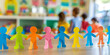 © MNStudio - Rainbow colored paper human figures holding their hands on kindergarten or school background. Diversity and inclusion concept.