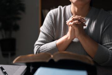 Wall Mural - Woman with Bible in her hand, her faith unwavering as she prayed and worshiped God, finding strength and guidance in her Christian religion through the holy book. pray, woman, bible, faith, religion.