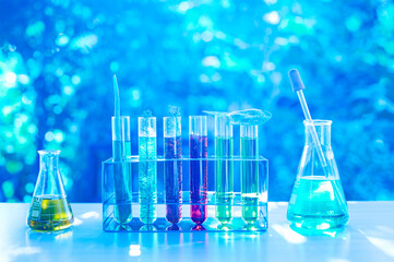 Wall Mural - A collection of glass beakers and test tubes filled with various colored liquids. Concept of scientific experimentation and discovery. Chemistry science nature concept.