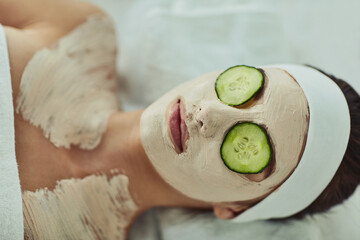 Wall Mural - Woman, spa and facemask with cucumber, beauty and organic treatment for eye rejuvenation or skin wellness. Pore tightening, facial and client relaxing for skincare, hydration and soothing detox