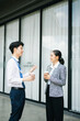 © Nuttapong punna - Businessman and woman going in city center in smart casual business style, talking, working together, stylish freelance people
