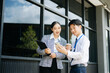 © Nuttapong punna - Businessman and woman going in city center in smart casual business style, talking, working together, stylish freelance people