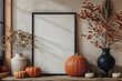 © Iryna - Blank vertical frame for wall art mock up on the table with fall decor with pumpkins and vase. Rustic living room interior.