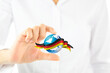 © FATIR29 - A hand holding a globe with a red ribbon around it. Germany flag world shape and businesswoman