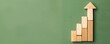 © Sorat - Wooden blocks arranged in ascending order forming a growth chart with green background, representing progress, success, and business growth.