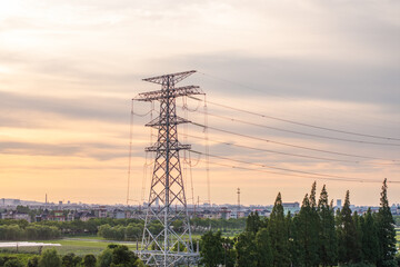 power pylon in field at sunset