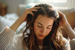 © Alexandra - Young woman is giving herself a relaxing head massage at home to promote hair growth