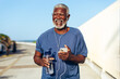 © (JLco) Julia Amaral - Smiling senior Black man enjoying a morning run