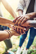 © Penn/peopleimages.com - Hands, together and stack for team building with people outdoor, support and solidarity in nature. Community, mission and partnership, trust and commitment with loyalty, group huddle and agreement