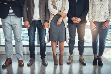 Wall Mural - Business people, closeup and legs with footwear, shoes and creative agency for cooperation. Feet, patience and employees in workplace, collaboration and style with teamwork, fashion and group waiting