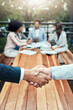 © BestLens/peopleimages.com - Meeting, business people and teamwork with handshake for welcome, introduction and onboarding outdoor. Cafe, accountants employees and shaking hands for partnership, agreement and b2b deal by closeup