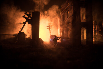 Wall Mural - War Concept. Battle scene on war fog sky background, Fighting silhouettes Below Cloudy Skyline at night. City destroyed by war