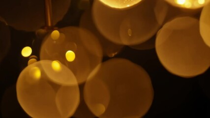 Wall Mural - on a black background, blurred bokeh circles appear, creating a dreamy and abstract effect.