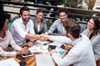 © peopleimages.com - Cafe, business people and shaking hands for teamwork, success and partnership in finance project. B2B, professional career and accountant for collaboration, agreement and solidarity with handshake