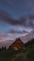 Wall Mural - clouds and milky way galaxy stars moving fast over wooden forest house in summer night