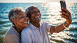 © Wabisabi - Coppia di anziani di origine afro americana si fanno un selfie con il cellulare e sorridono felici in riva al mare