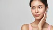 © SC Media - Beautiful Asian woman with flawless skin. Skincare concept. Beautiful young Asian woman practicing skincare. smooth face touches her healthy facial skin. Copy space for text.
