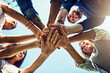 © Penn/peopleimages.com - Hands, low angle and pile for team building with friends outdoor, support and solidarity in nature. Community, mission and partnership, trust and commitment with loyalty, group huddle and agreement