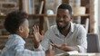 © Nicholas - An engaged teacher is seen involved with a student in discussion during a classroom session, portraying an effective learning environment and rapport-building.