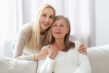 Canvas Print - Family portrait of young woman and her mother at home