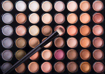 Palette of colorful eye shadows with brush